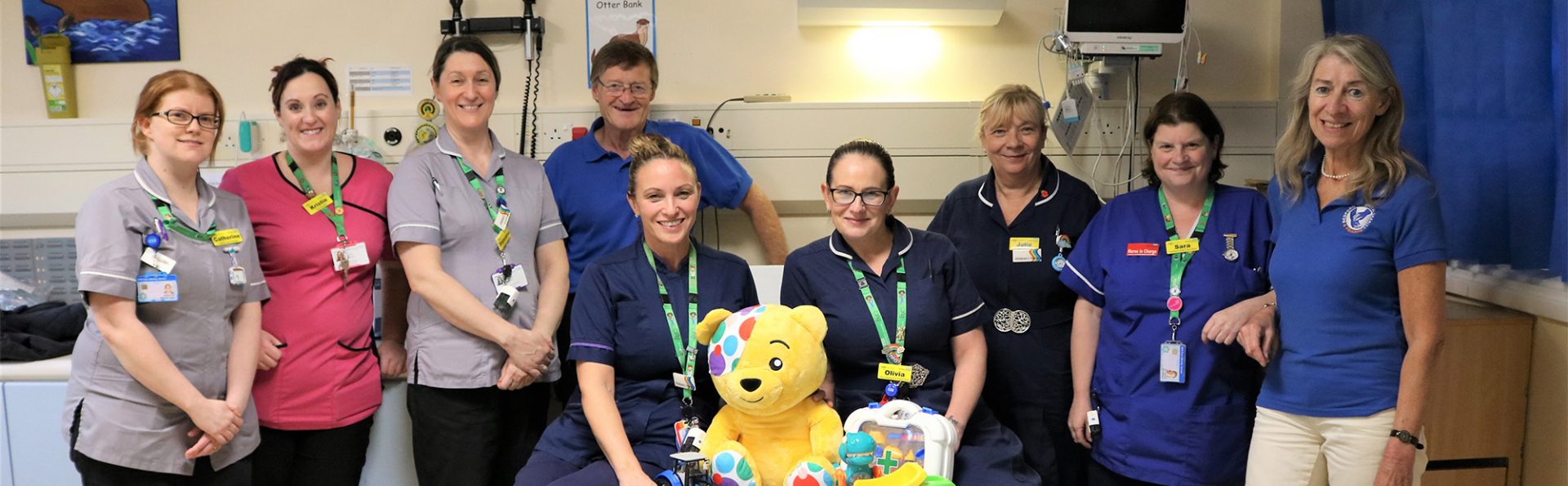 Rob (centre) and Debbie (far left) from BHC&F with Bedford Hospital Riverbank Ward staff slider