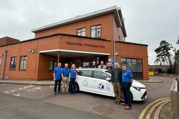 Representatives from the Panacea Charitable Trust, Primrose Car Service drivers and BHC&F committee members welcome one of the new vehicles.